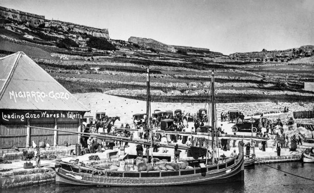 Wares being unloaded at Mgarr harbour, captured by Salvatore Lorenzo Cassar, circa 1910.