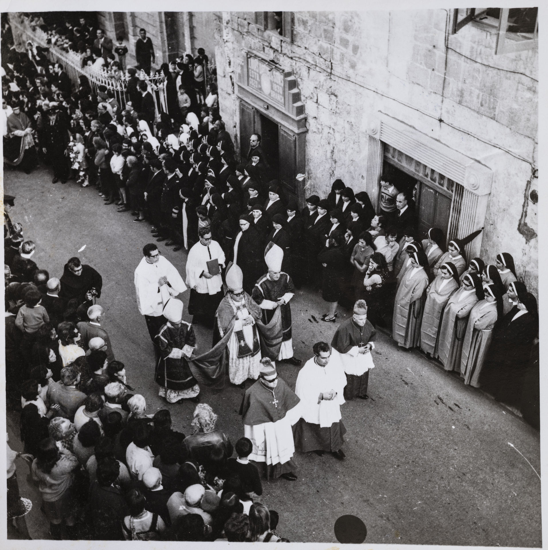 A funeral approaching the Cathedral within the Citadel.