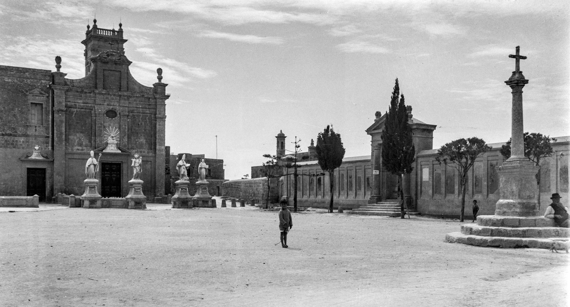 A view of Fuq it-Tomba square, with the chapel of St. Augustine and the now demolished cemetery in the background; photographer unknown, circa 1930.