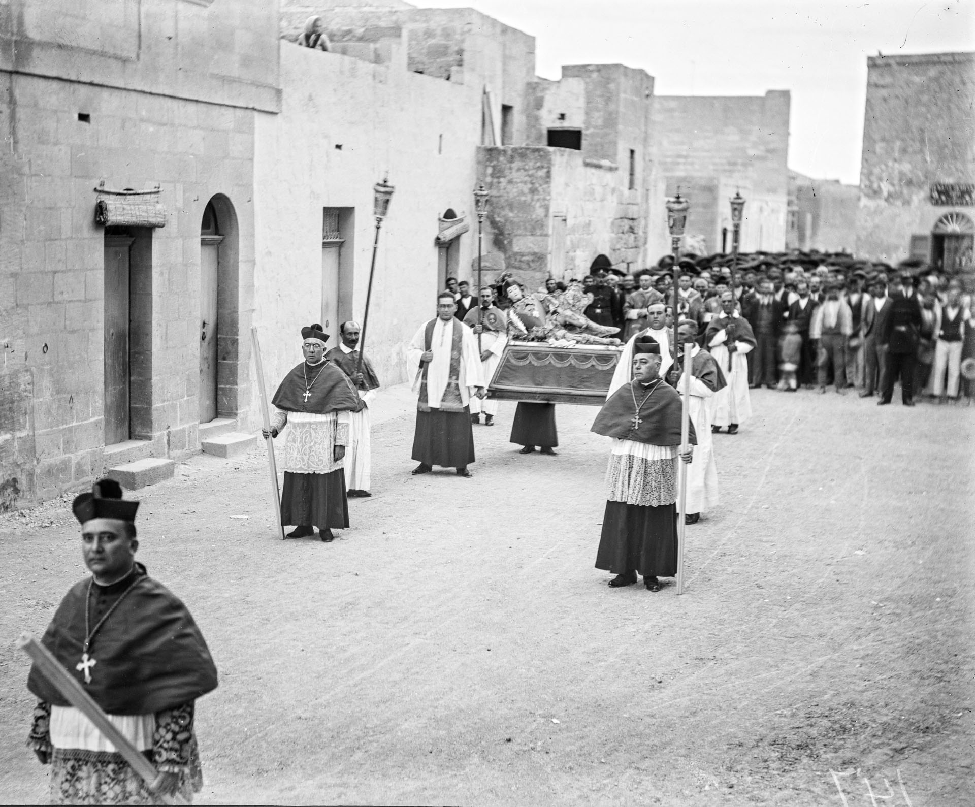 A procession with the blessed relic of St Coronato in Nadur passing through the main street of the town, 1920.