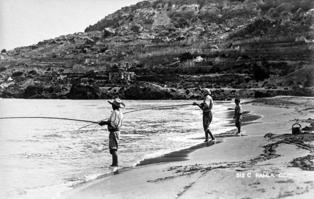 Three fishermen plying their hobby at Ramla Bay, captured by EA Gouder, 1920s.