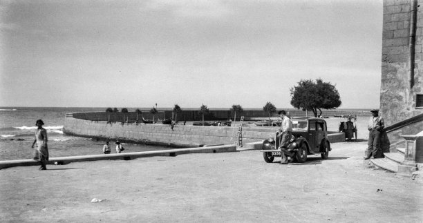 A pristine Marsalforn bay with one of the early vehicles in Gozo, circa 1930.