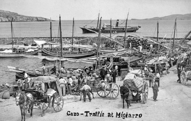 Wares being unloaded at Mgarr harbour, captured by Salvatore Lorenzo Cassar, circa 1910.