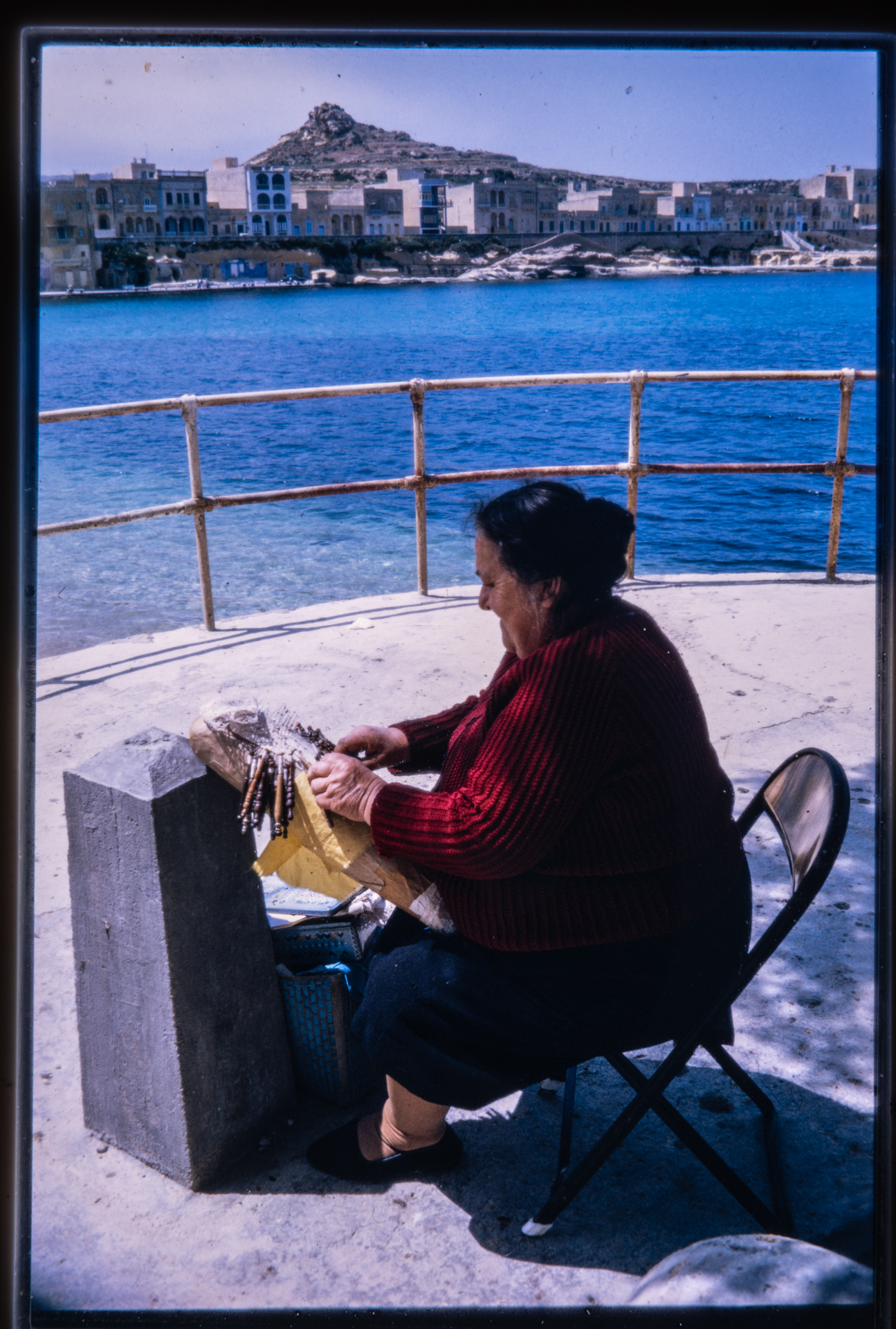 A lace worker showcasing her skill in Marsalforn in 1971.