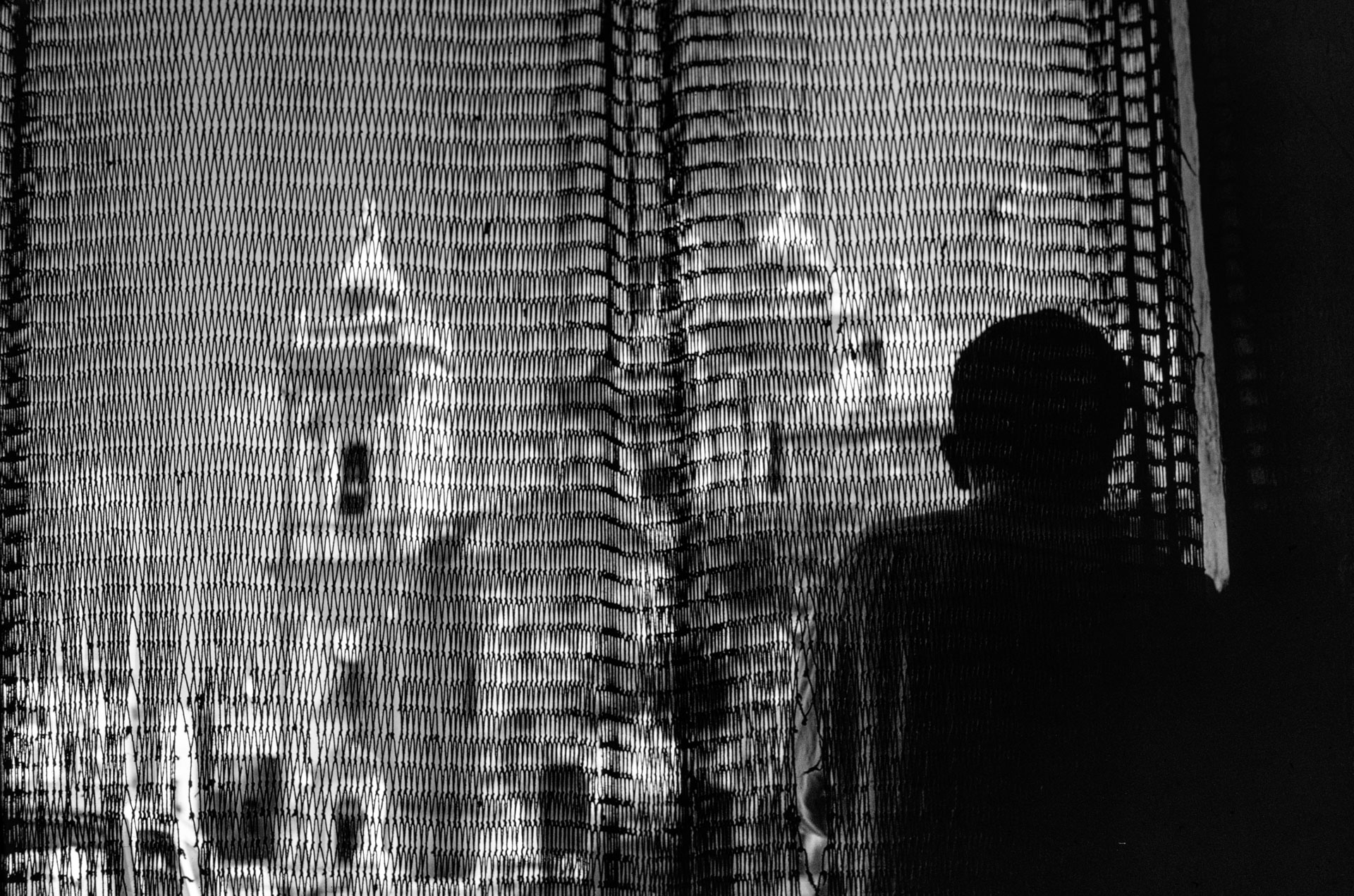The parish church of Xaghra captured through a curtain by Guido Stilon.