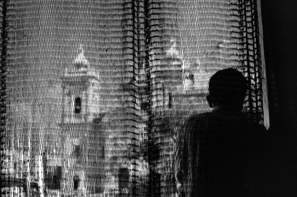 The parish church of Xaghra captured through a curtain by Guido Stilon.