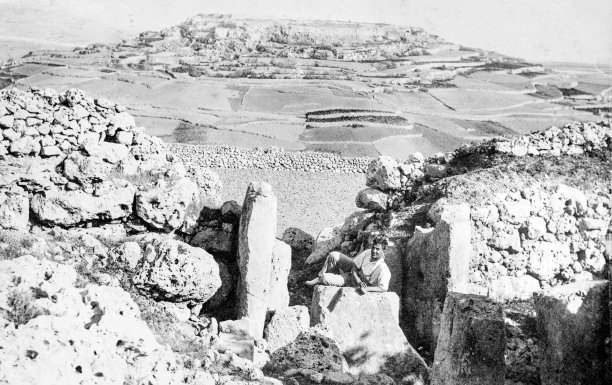A man lies atop a megalith within Ggantija temples in Xaghra; photographer unknown.